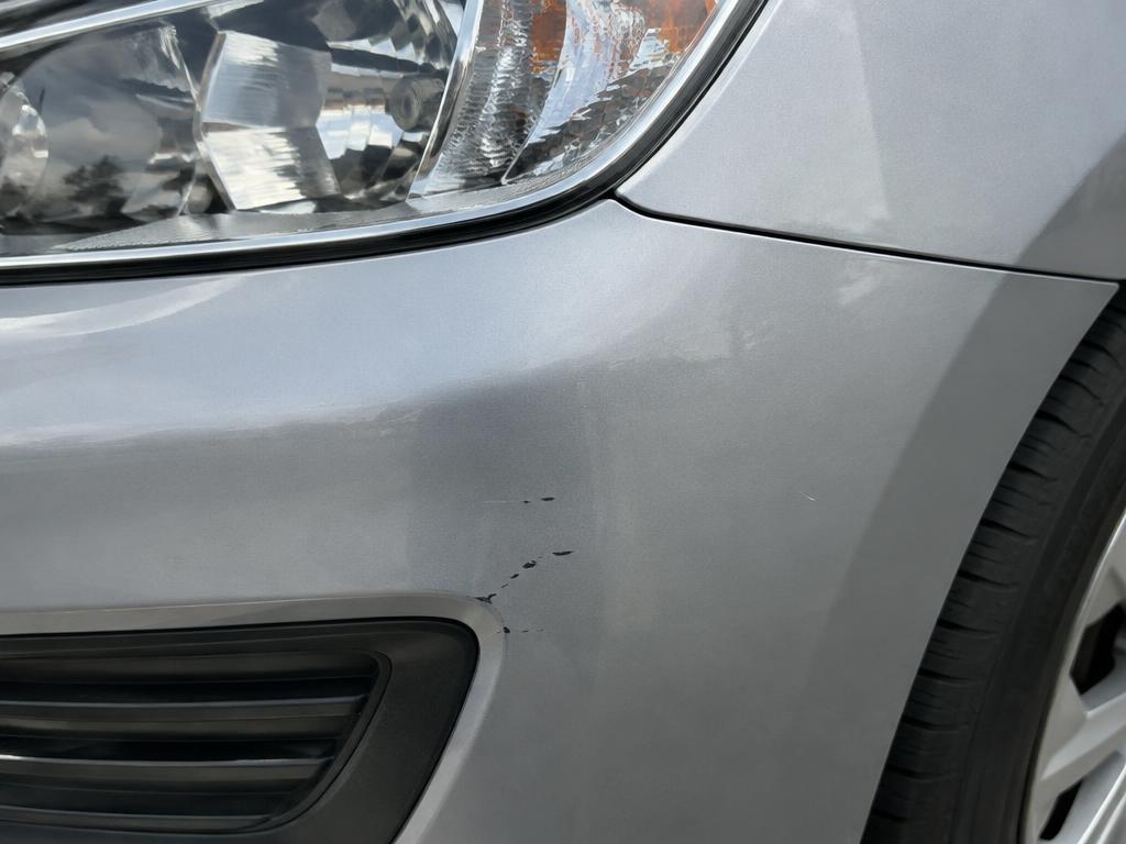 Close-up documentation photograph of a vehicle's paint surface and panel gap